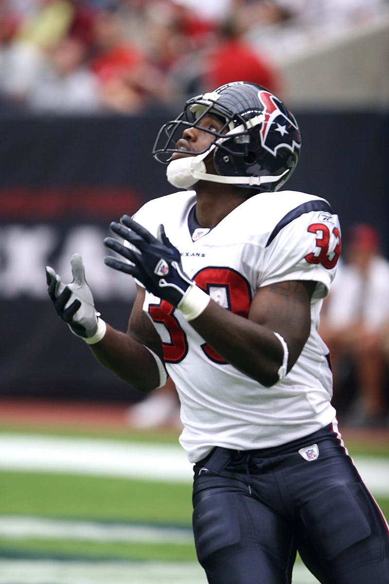 Football player in uniform concentrating during a game on the field.